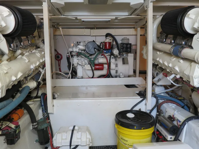 Slide: The Image of Engine room of a 1997 Post 50 Flybridge yacht with visible machinery and equipment. - 18
