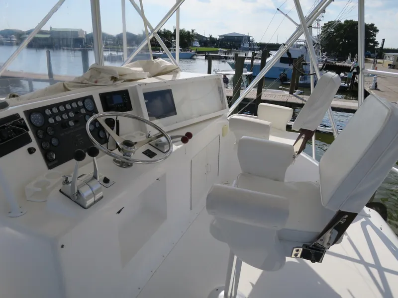Slide: The Image of 1997 Post 50 Flybridge helm with dual captain chairs and control panel. - 4