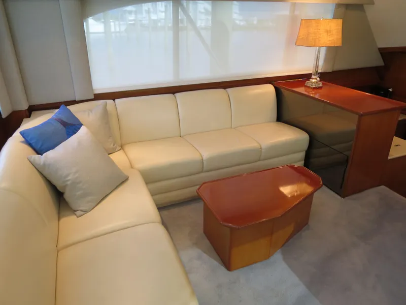 Slide: The Image of Luxurious 1997 Post 50 Flybridge yacht interior with cream leather sofa and wooden table. - 7