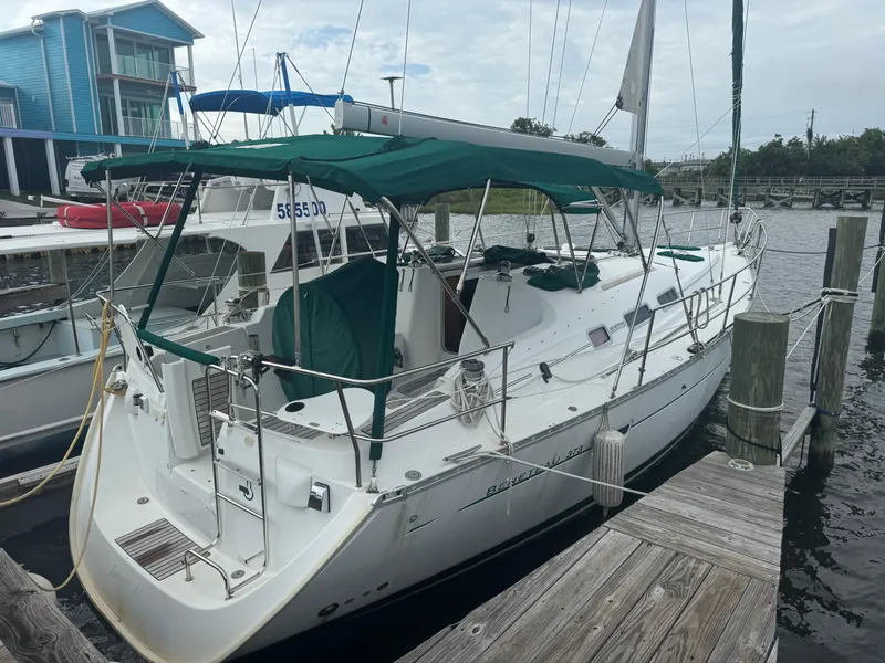 Slide: The Image of 2005 Beneteau Oceanis Clipper 373 sailboat docked at marina with green canopy. - 0