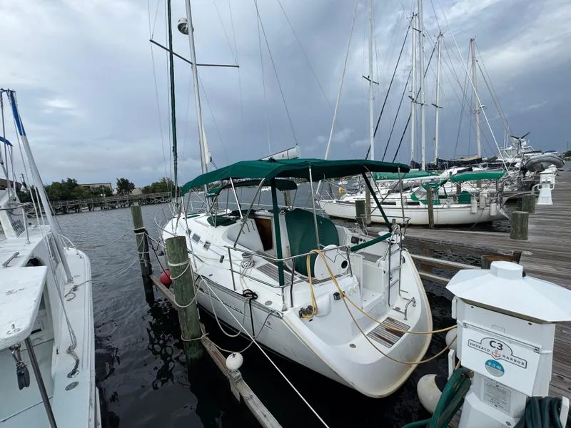 Slide: The Image of 2005 Beneteau Oceanis Clipper 373 sailboat docked at marina under cloudy sky. - 1