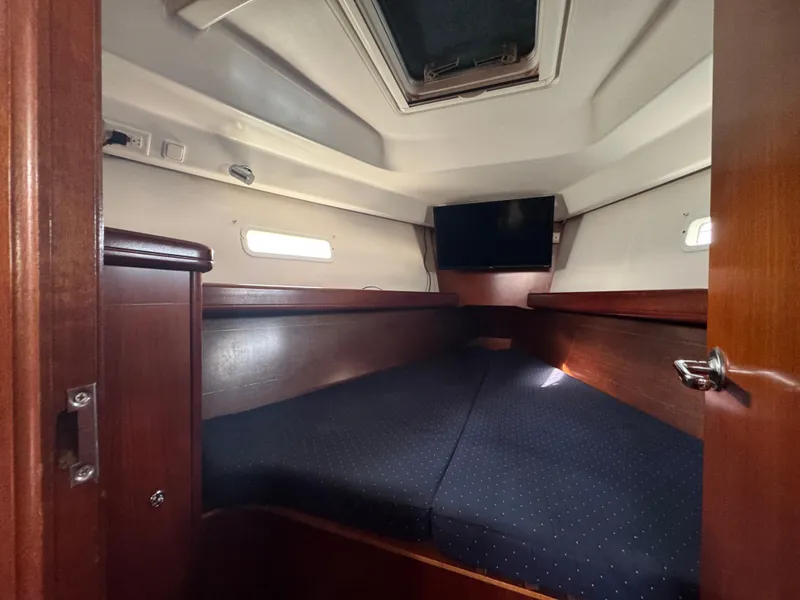 Slide: The Image of Cozy cabin interior of 2005 Beneteau Oceanis Clipper 373 sailboat with wood finish and skylight. - 12