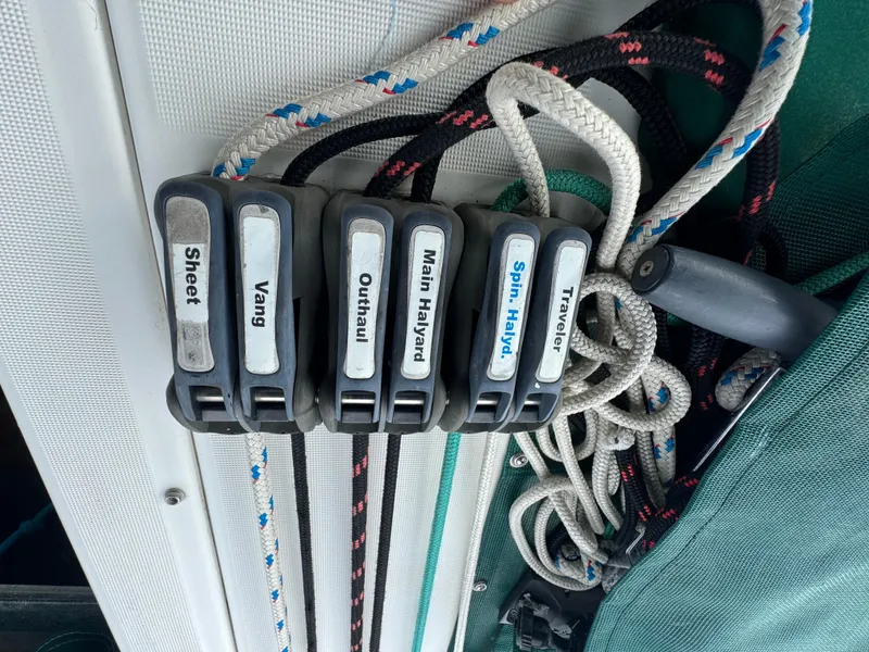 Slide: The Image of Sailing rope clutches labeled for sheet, vang, outhaul, halyards, and traveler on a Beneteau Oceanis Clipper 373. - 22