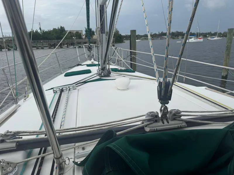 Slide: The Image of 2005 Beneteau Oceanis Clipper 373 sailboat deck with rigging, docked by the water. - 23