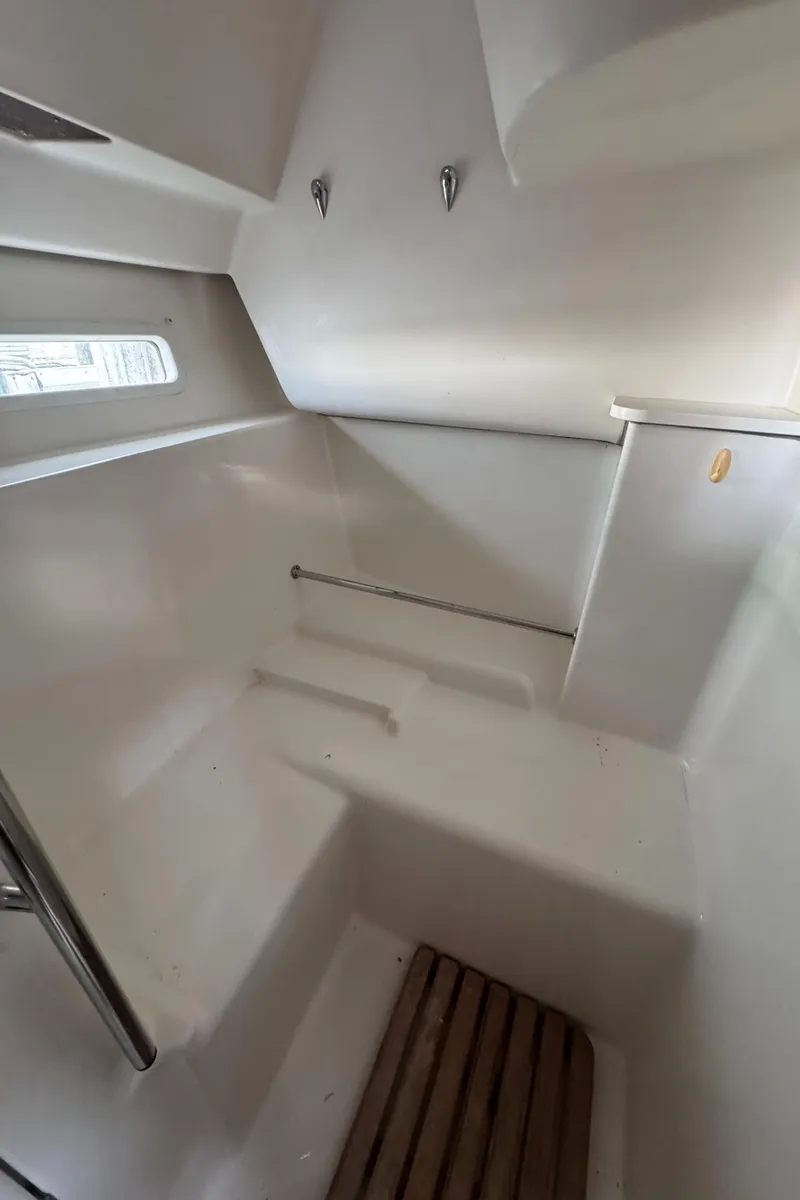 Slide: The Image of Interior of 2005 Beneteau Oceanis Clipper 373 sailboat, featuring a clean, white cabin space. - 26