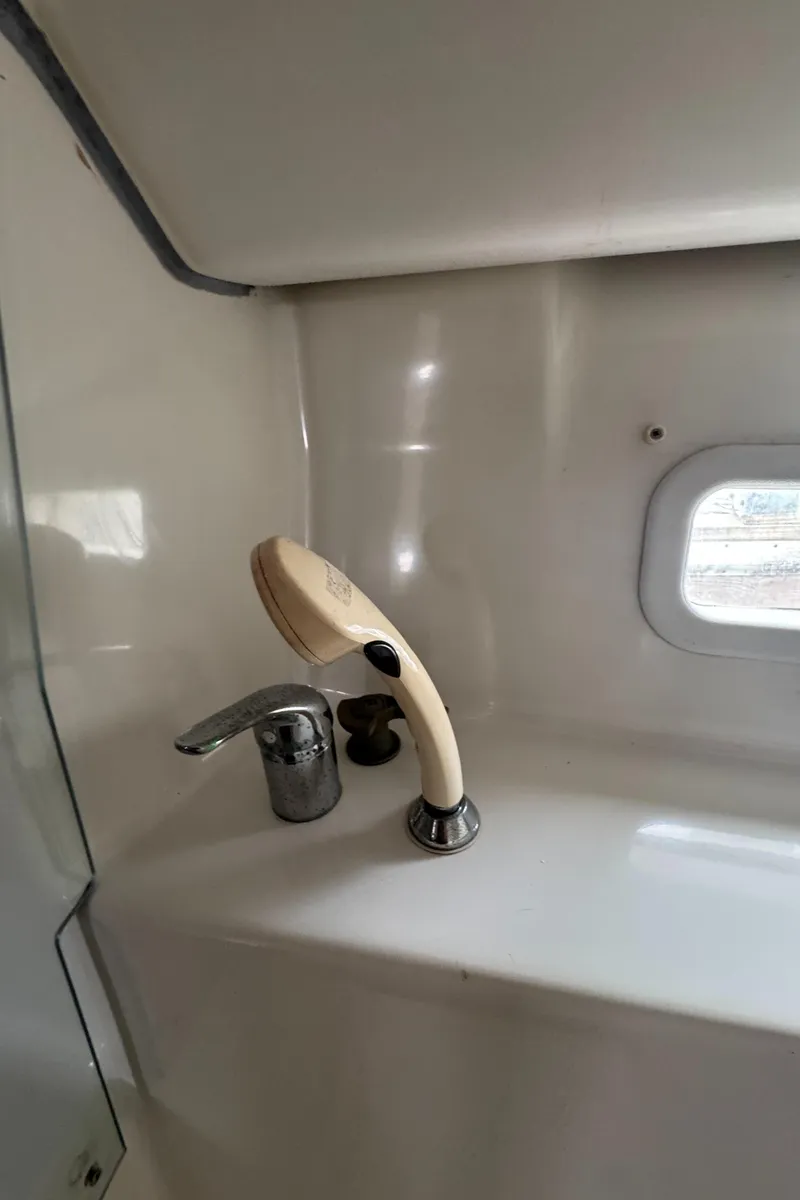 Slide: The Image of Interior of 2005 Beneteau Oceanis Clipper 373, featuring a compact sink and faucet. - 27