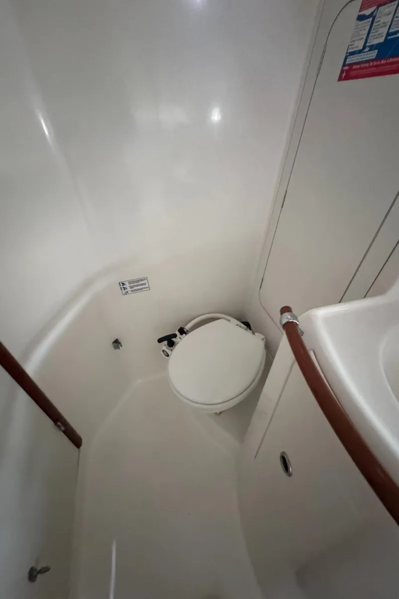 Slide: The Image of Bathroom interior of 2005 Beneteau Oceanis Clipper 373 sailboat, featuring compact marine toilet. - 28