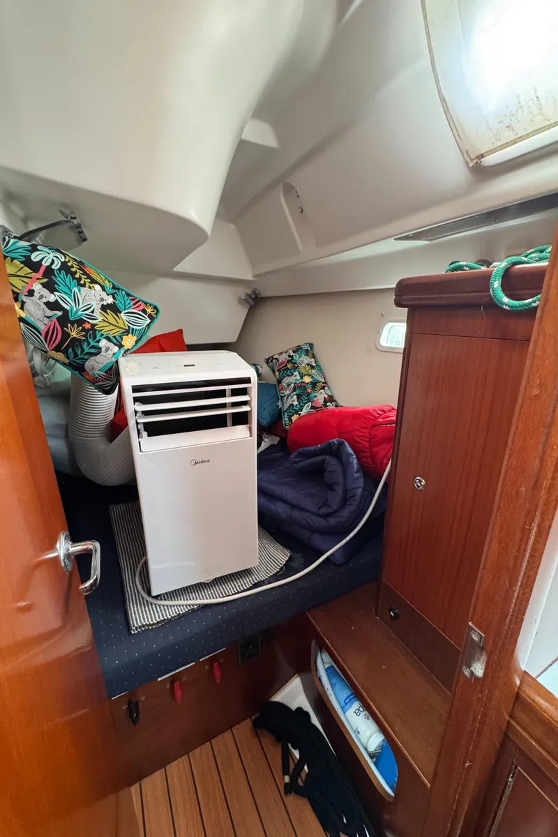 Slide: The Image of Cozy cabin interior of 2005 Beneteau Oceanis Clipper 373 with colorful pillows and portable air conditioner. - 29