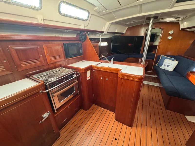 Slide: The Image of Interior of 2005 Beneteau Oceanis Clipper 373 yacht with kitchen and seating area. - 6