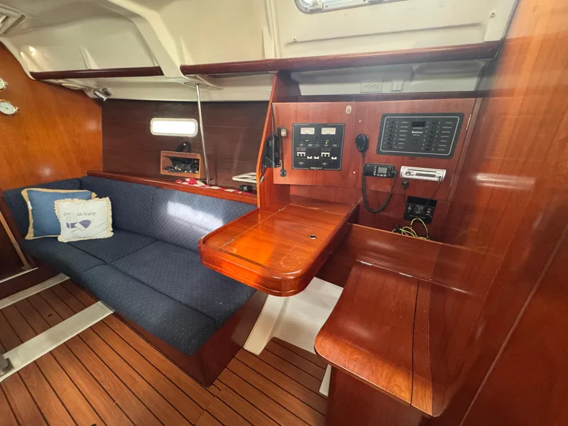 Slide: The Image of Interior of 2005 Beneteau Oceanis Clipper 373 with wooden finish and blue sofa. - 7