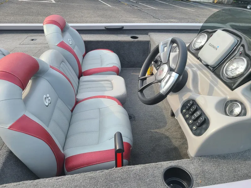 Slide: The Image of 2013 G3 Eagle Talon 17 DLX boat interior with red and gray seats, steering wheel, and Garmin display. - 8