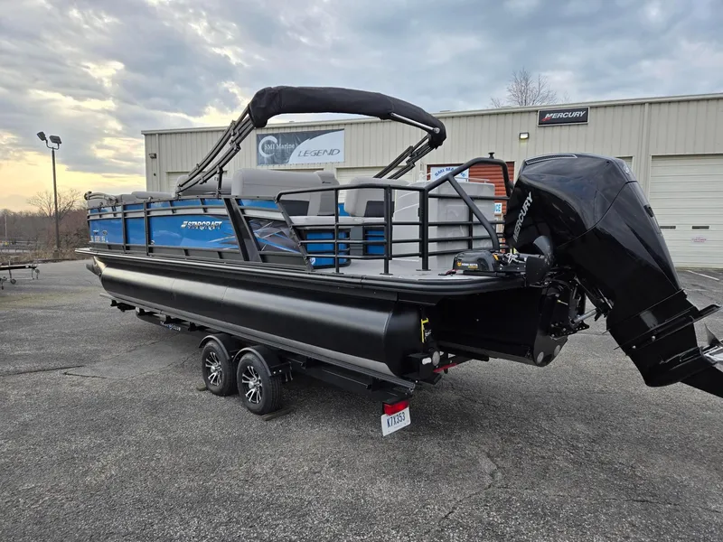 Slide: The Image of 2024 Starcraft CX25RL pontoon boat with Mercury outboard motor on a trailer. - 4
