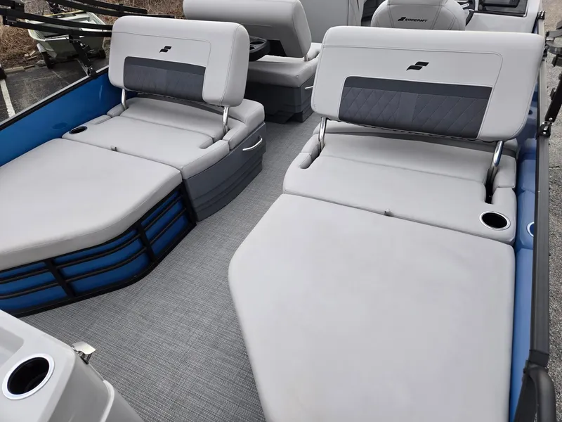 Slide: The Image of 2024 Starcraft CX25RL boat interior with gray cushioned seating and cup holders. - 6
