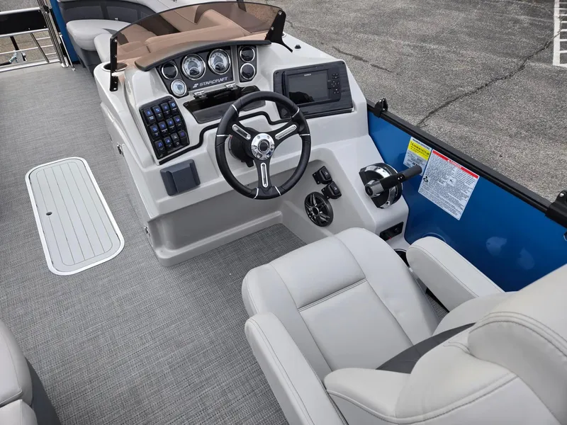 Slide: The Image of 2024 Starcraft CX25RL boat interior with modern dashboard and comfortable seating. - 9