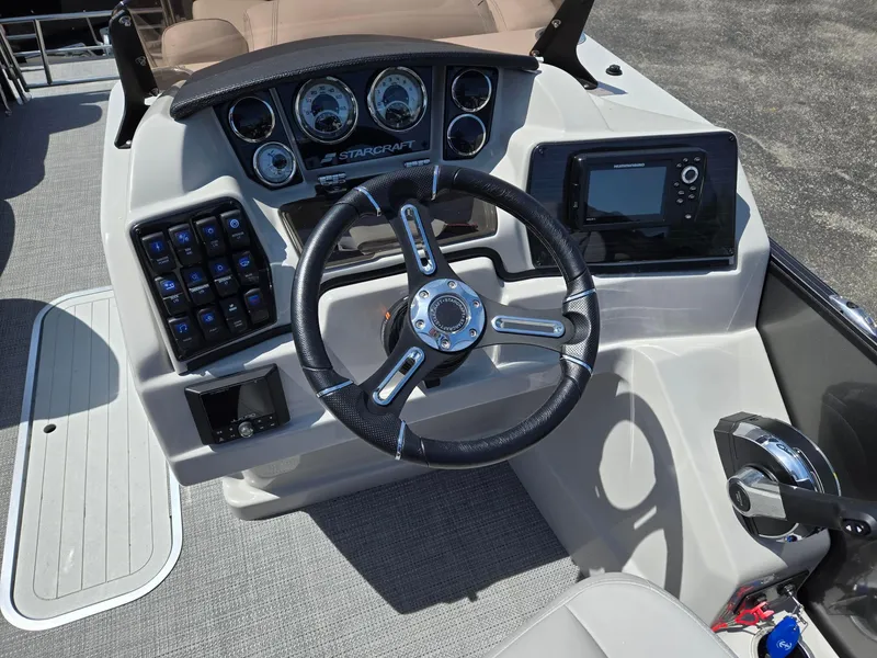 Slide: The Image of 2024 Starcraft Sls3qdh boat dashboard with steering wheel and control panel. - 7