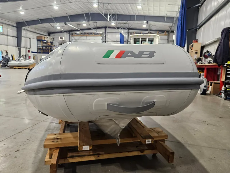 Slide: The Image of 2024 AB Inflatables 9AL boat in a warehouse, displayed on wooden pallets. - 5