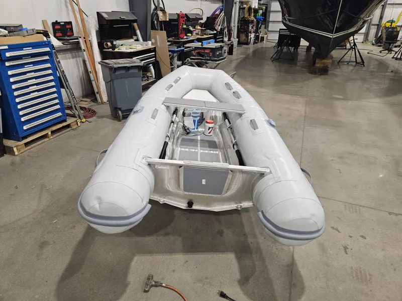 Slide: The Image of 2024 AB Inflatables 9AL boat in workshop, surrounded by tools and equipment. - 6