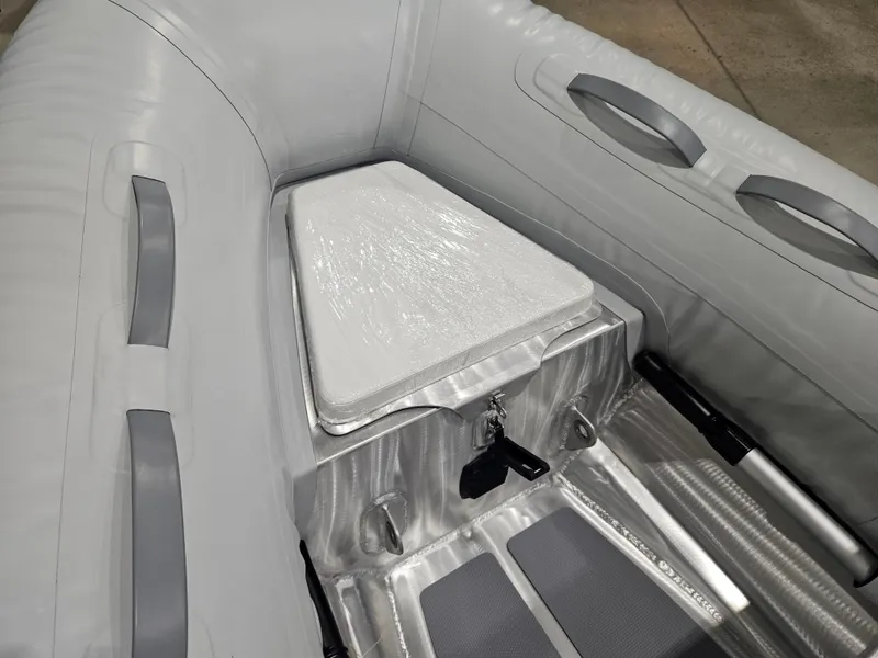 Slide: The Image of 2024 AB Inflatables 9AL boat interior with storage compartment and handles. - 8