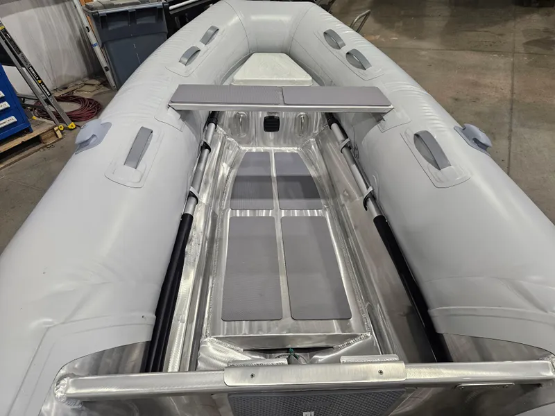 Slide: The Image of 2024 AB Inflatables 9AL boat interior with aluminum flooring and seating. - 9