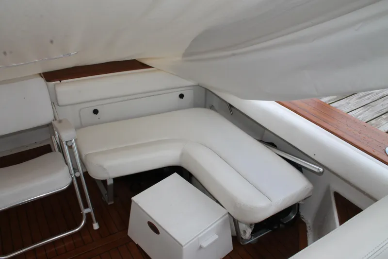 Slide: The Image of 2004 Tiara Yachts 2900 Coronet interior with white seating and wooden flooring. - 12