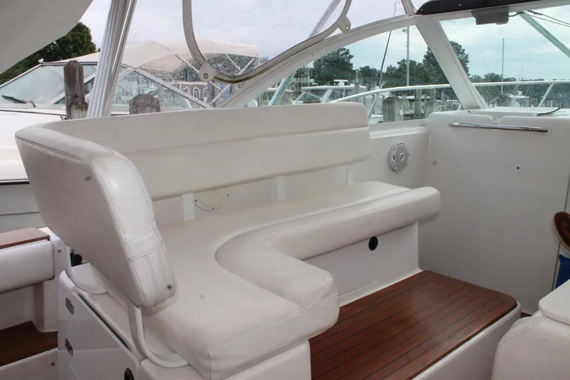 Slide: The Image of 2004 Tiara Yachts 2900 Coronet interior with white seating and wooden flooring. - 13