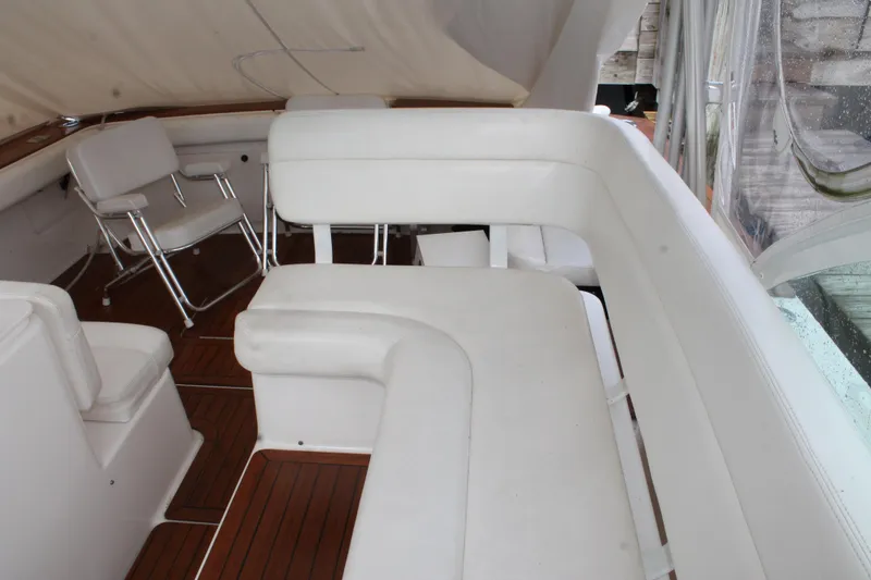 Slide: The Image of 2004 Tiara Yachts 2900 Coronet interior with white seating and wooden flooring. - 14