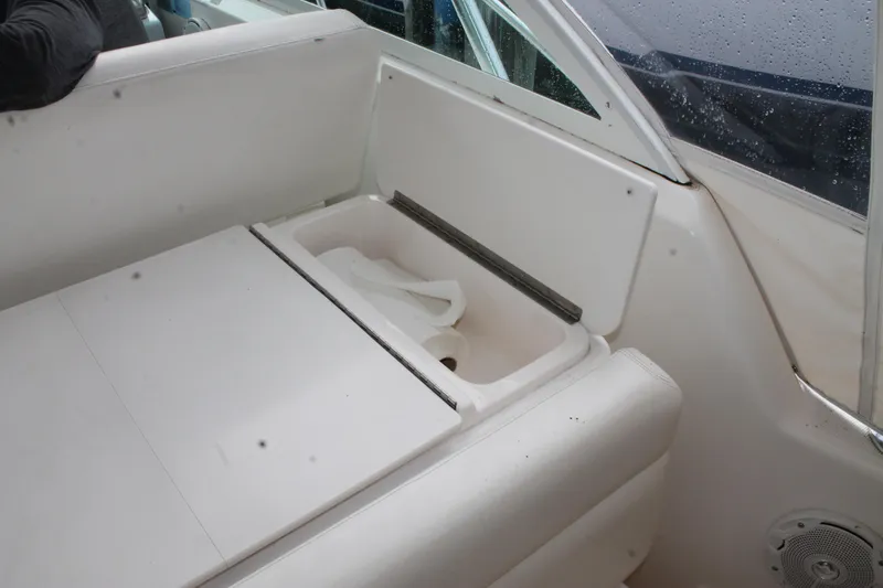 Slide: The Image of 2004 Tiara Yachts 2900 Coronet interior with white seating and storage compartment. - 15