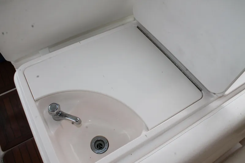 Slide: The Image of 2004 Tiara Yachts 2900 Coronet sink with faucet and drain, white surface. - 16