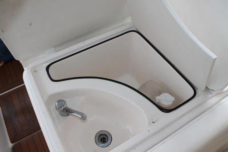 Slide: The Image of 2004 Tiara Yachts 2900 Coronet sink with faucet and storage compartment. - 17