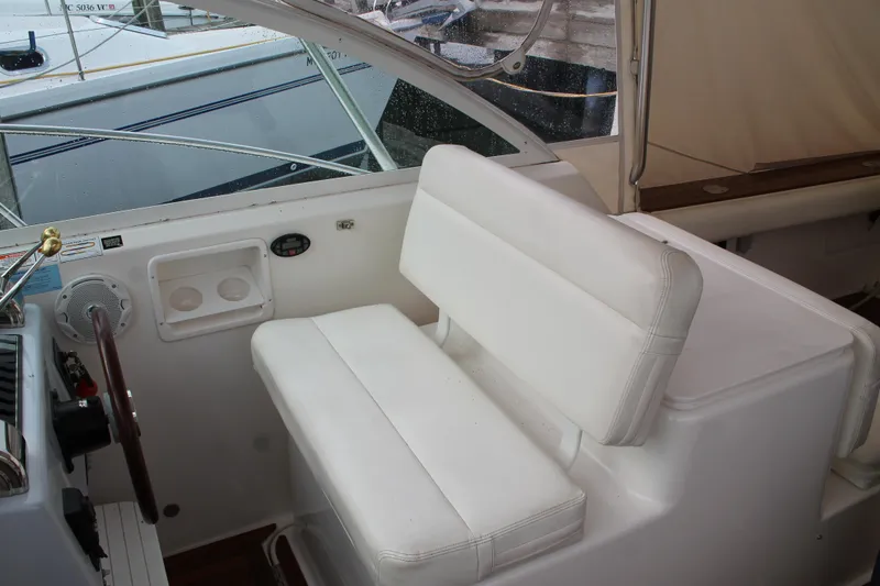 Slide: The Image of 2004 Tiara Yachts 2900 Coronet interior with white seating and helm controls. - 18