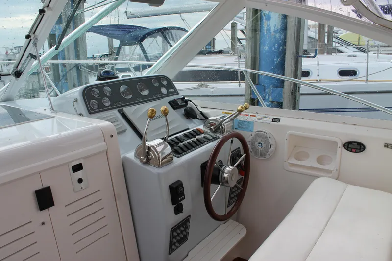 Slide: The Image of 2004 Tiara Yachts 2900 Coronet helm with controls and steering wheel, docked at marina. - 19