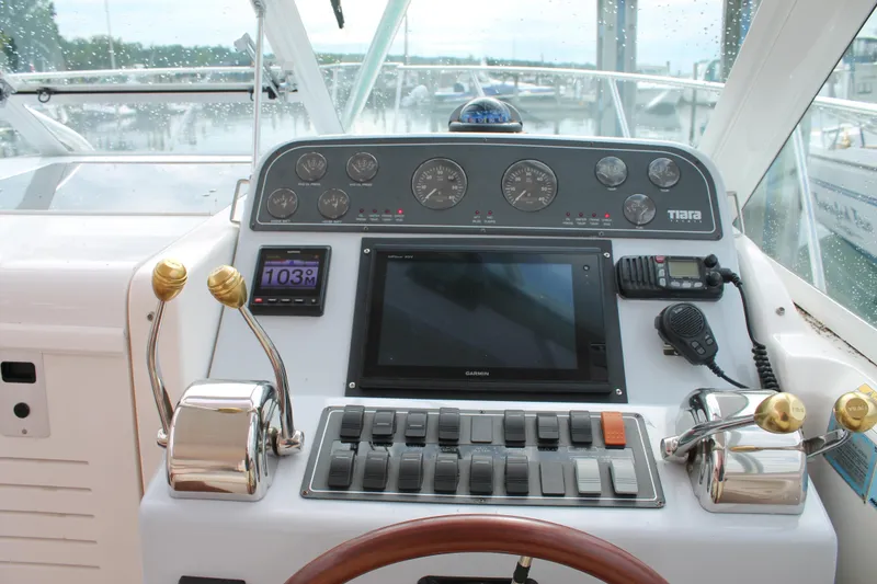 Slide: The Image of 2004 Tiara Yachts 2900 Coronet dashboard with navigation controls and instruments. - 21
