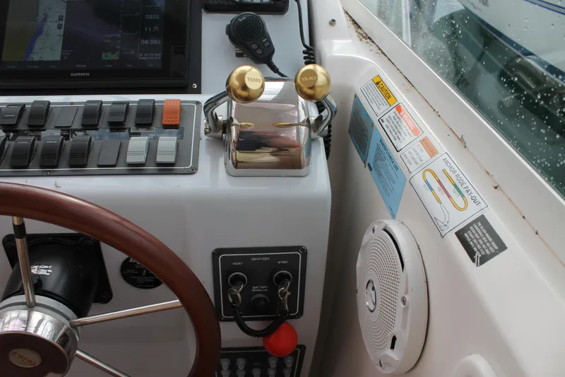 Slide: The Image of 2004 Tiara Yachts 2900 Coronet helm with controls, steering wheel, and navigation equipment. - 29