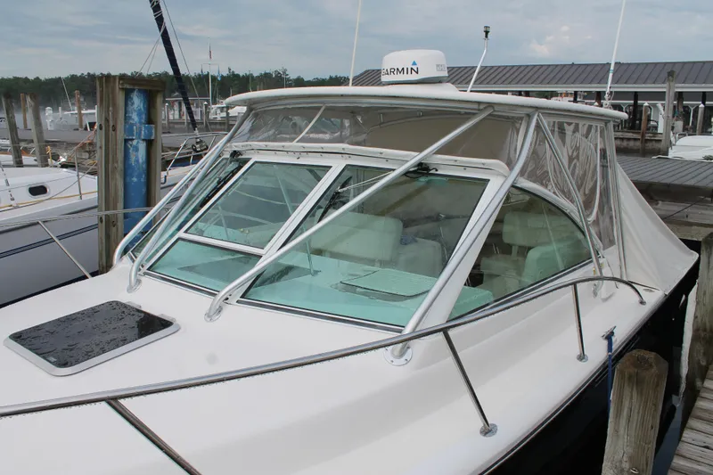 Slide: The Image of 2004 Tiara Yachts 2900 Coronet docked, featuring a sleek design and Garmin equipment. - 3