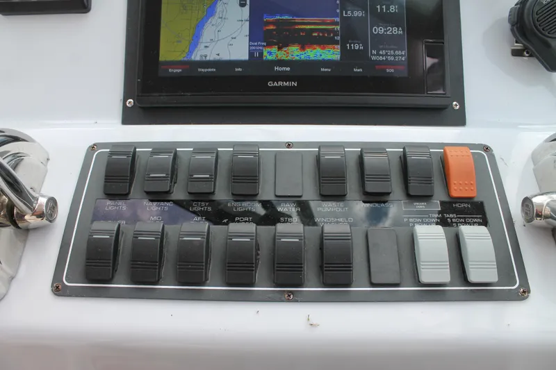 Slide: The Image of Control panel of a 2004 Tiara Yachts 2900 Coronet with switches and Garmin display. - 30