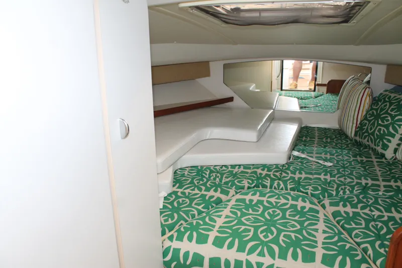 Slide: The Image of 2004 Tiara Yachts 2900 Coronet cabin with green patterned bedding and white cushions. - 33
