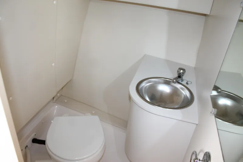 Slide: The Image of 2004 Tiara Yachts 2900 Coronet bathroom with toilet and stainless steel sink. - 36