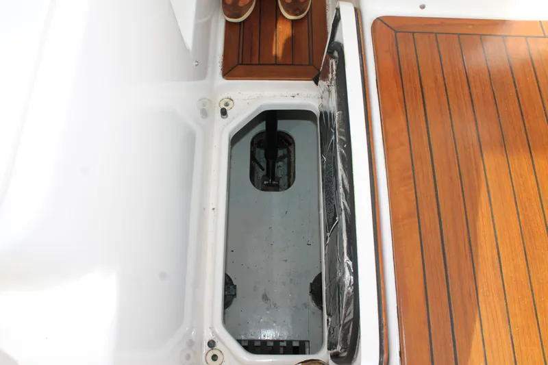 Slide: The Image of 2004 Tiara Yachts 2900 Coronet deck with open storage compartment and wooden flooring. - 37