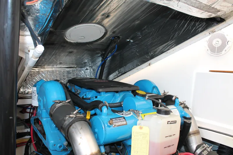 Slide: The Image of Engine compartment of 2004 Tiara Yachts 2900 Coronet, featuring a blue marine engine. - 40