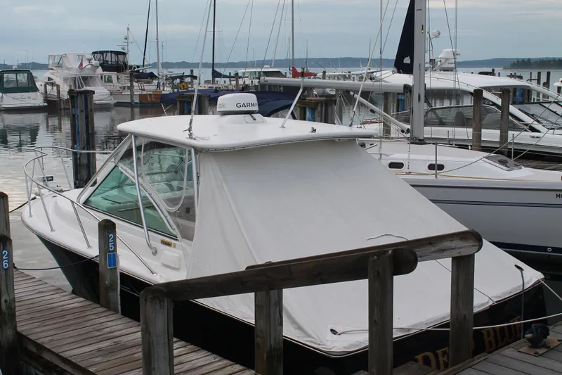 Slide: The Image of 2004 Tiara Yachts 2900 Coronet docked at marina with other boats. - 5