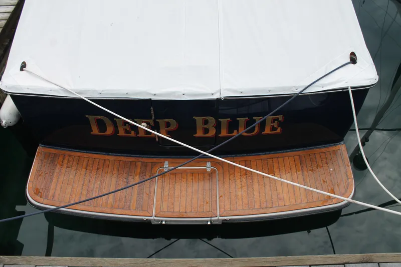 Slide: The Image of 2004 Tiara Yachts 2900 Coronet named "Deep Blue" docked with wooden deck. - 7
