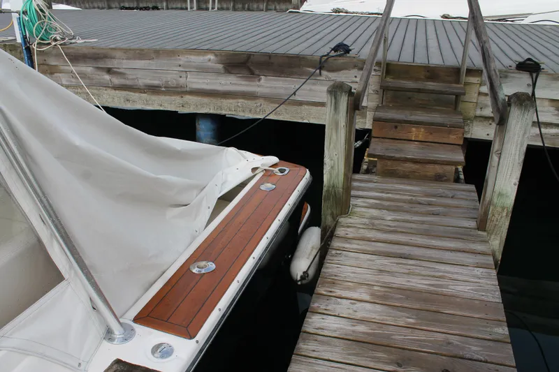 Slide: The Image of 2004 Tiara Yachts 2900 Coronet docked beside wooden pier with cover. - 8