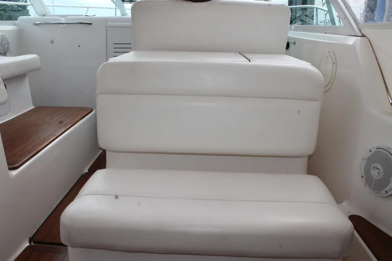 Slide: The Image of 2004 Tiara Yachts 2900 Coronet interior with white seating and wooden accents. - 9