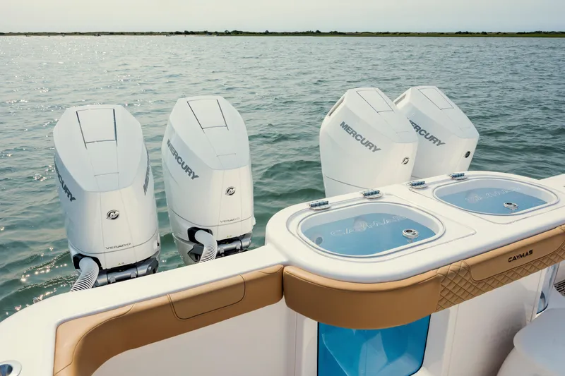 Slide: The Image of 2025 Caymas 44 CT boat with four Mercury Verado engines on open water. - 12