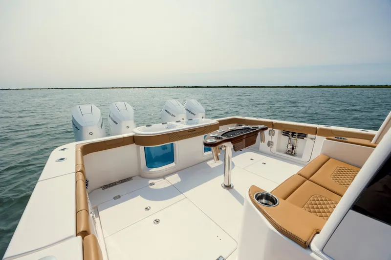 Slide: The Image of 2025 Caymas 44 CT boat with luxurious seating and powerful engines on open water. - 13