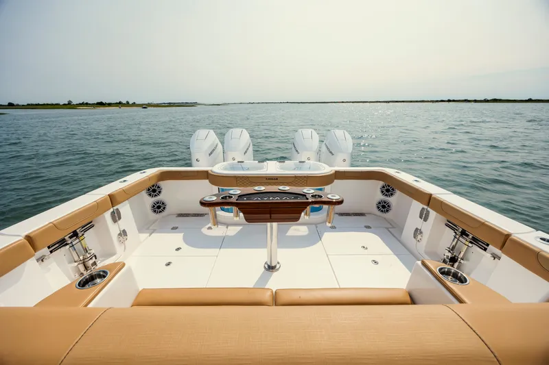 Slide: The Image of 2025 Caymas 44 CT boat deck with luxurious seating and powerful engines on open water. - 14