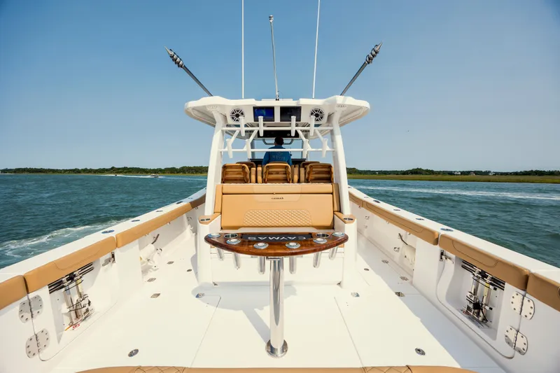 Slide: The Image of 2025 Caymas 44 CT boat interior with luxurious seating and fishing equipment on open water. - 17