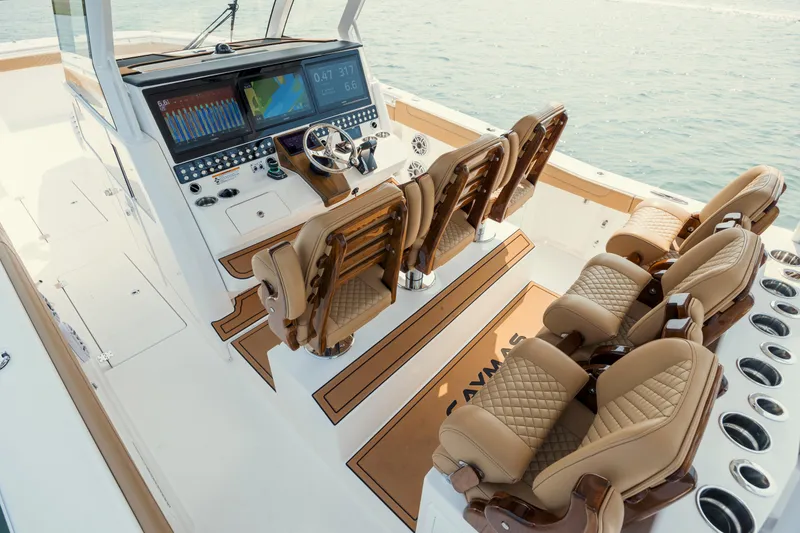Slide: The Image of Luxurious 2025 Caymas 44 CT boat interior with advanced navigation system and plush seating. - 19