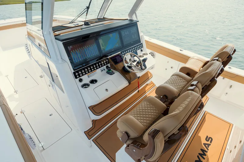 Slide: The Image of 2025 Caymas 44 CT boat cockpit with advanced navigation system and luxurious seating. - 20