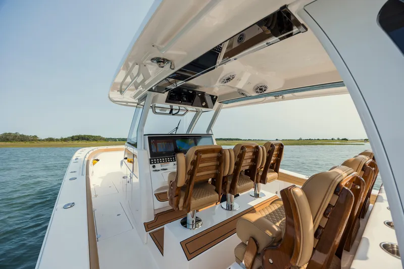 Slide: The Image of 2025 Caymas 44 CT boat interior with luxurious seating and advanced navigation system on open water. - 21